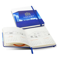 Blue customised notebook with a calendar open on a white background