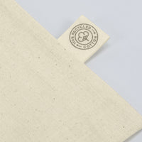 Beige cotton tote bag with a '100% Recycled Cotton' label on a light gray background
