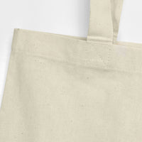 Close-up of a beige event tote bag on a white background