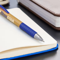 Blue pen with a visible brand name on a notebook