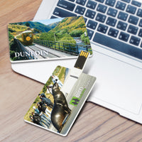 Two custom printed USB drives with scenic designs on a wooden surface with a laptop. Custom Branded | Promotional USB | BRAND KNEW PROMOTIONAL PRODUCTS