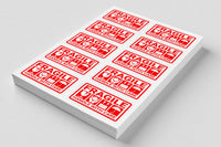 red and white stickers on a printed sheet with the words fragile
